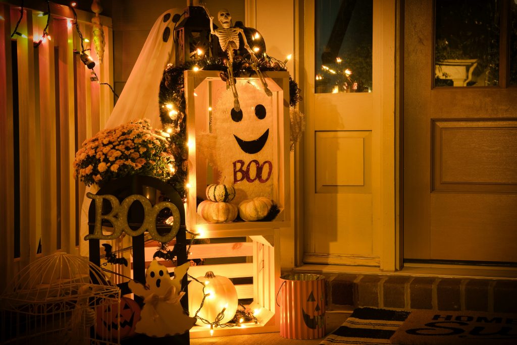 A Halloween-themed porch decoration showcases carved pumpkins and eerie accents, enhancing the seasonal spirit of the home.