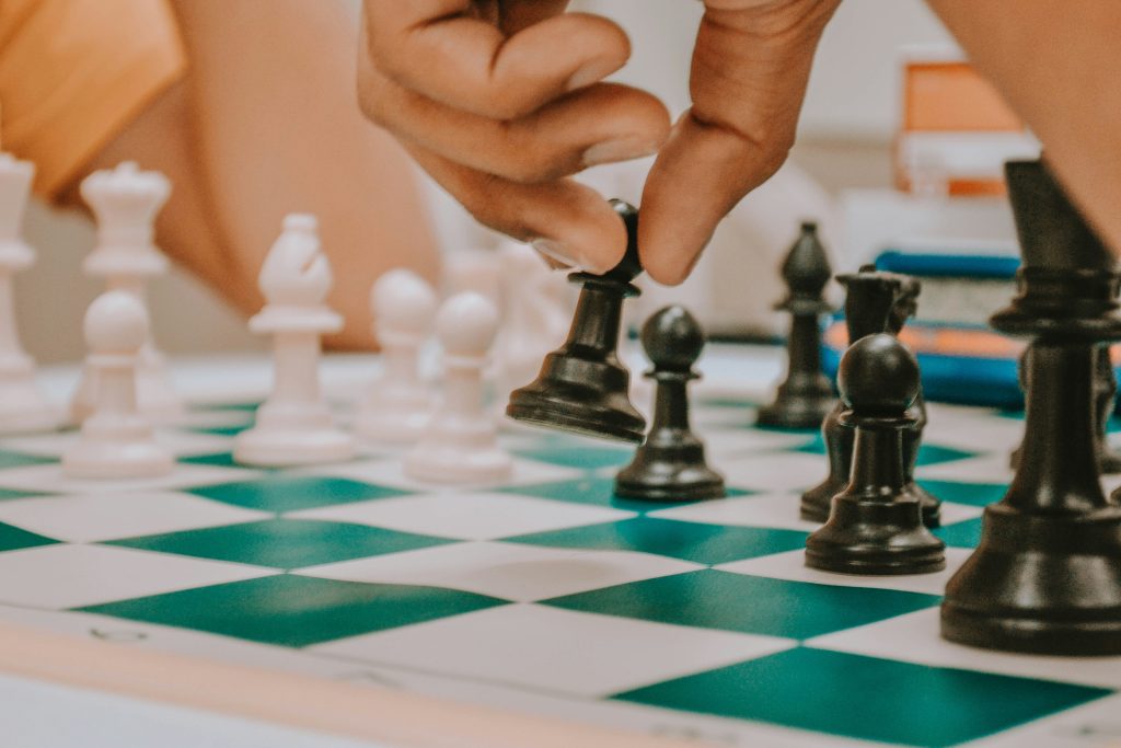 Close up on a person playing chess