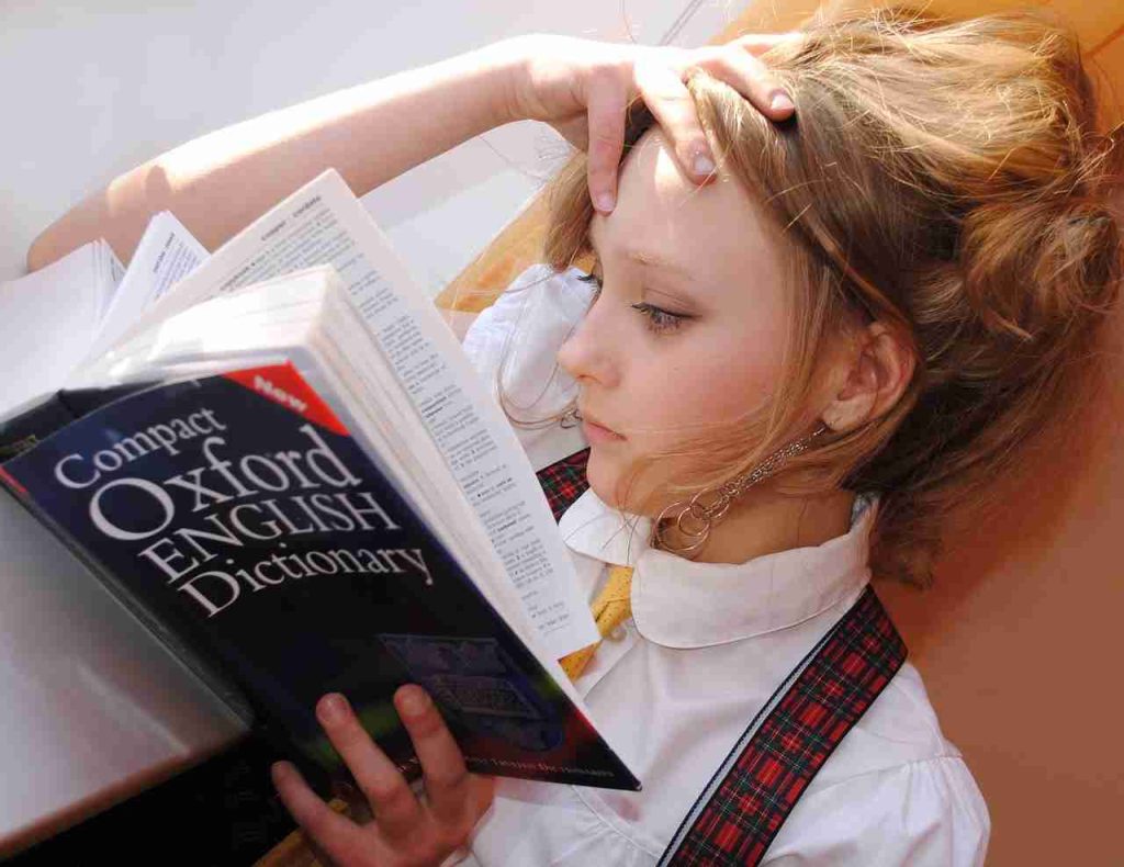 Girl reading an English dictionary.