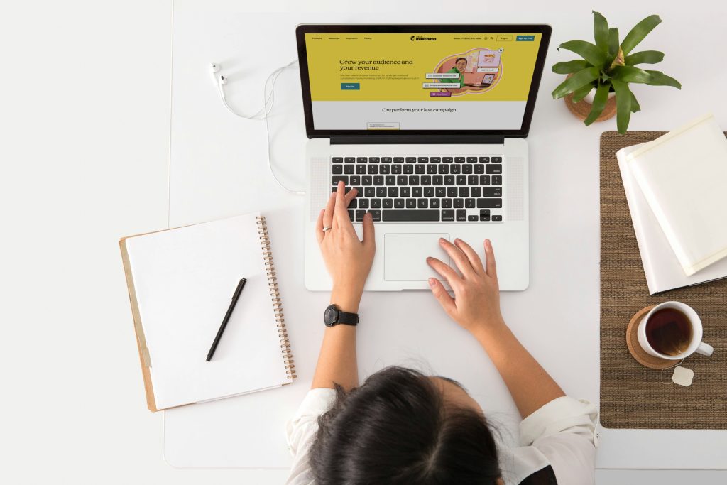 A woman seen from above working at her laptop