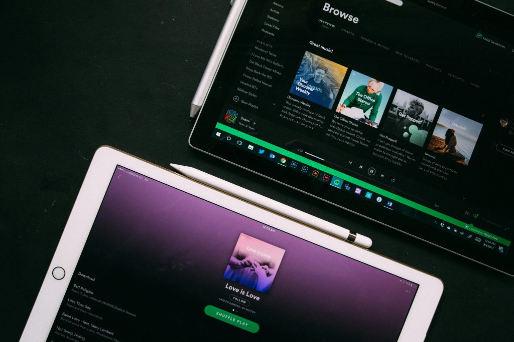 two Ipads open on spotify's homepge